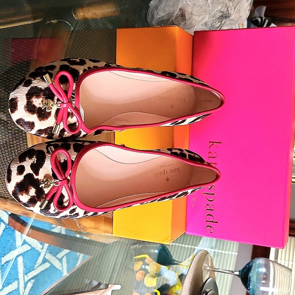 Kate Spade flat shoes. They are a size 9. They are tan with  brown leopard print